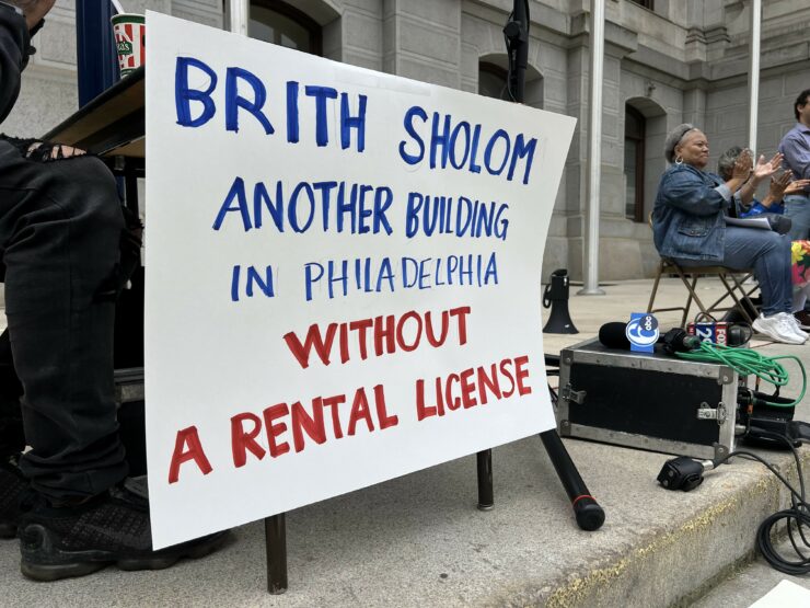 A sign at the May 4th rally reading "Brith Sholom Another Building in Philadelphia without a Rental License"